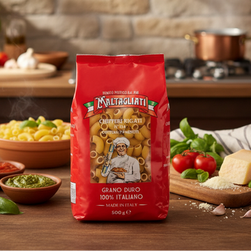 Red Maltagliati pasta bag on a kitchen counter with cooking ingredients in the background